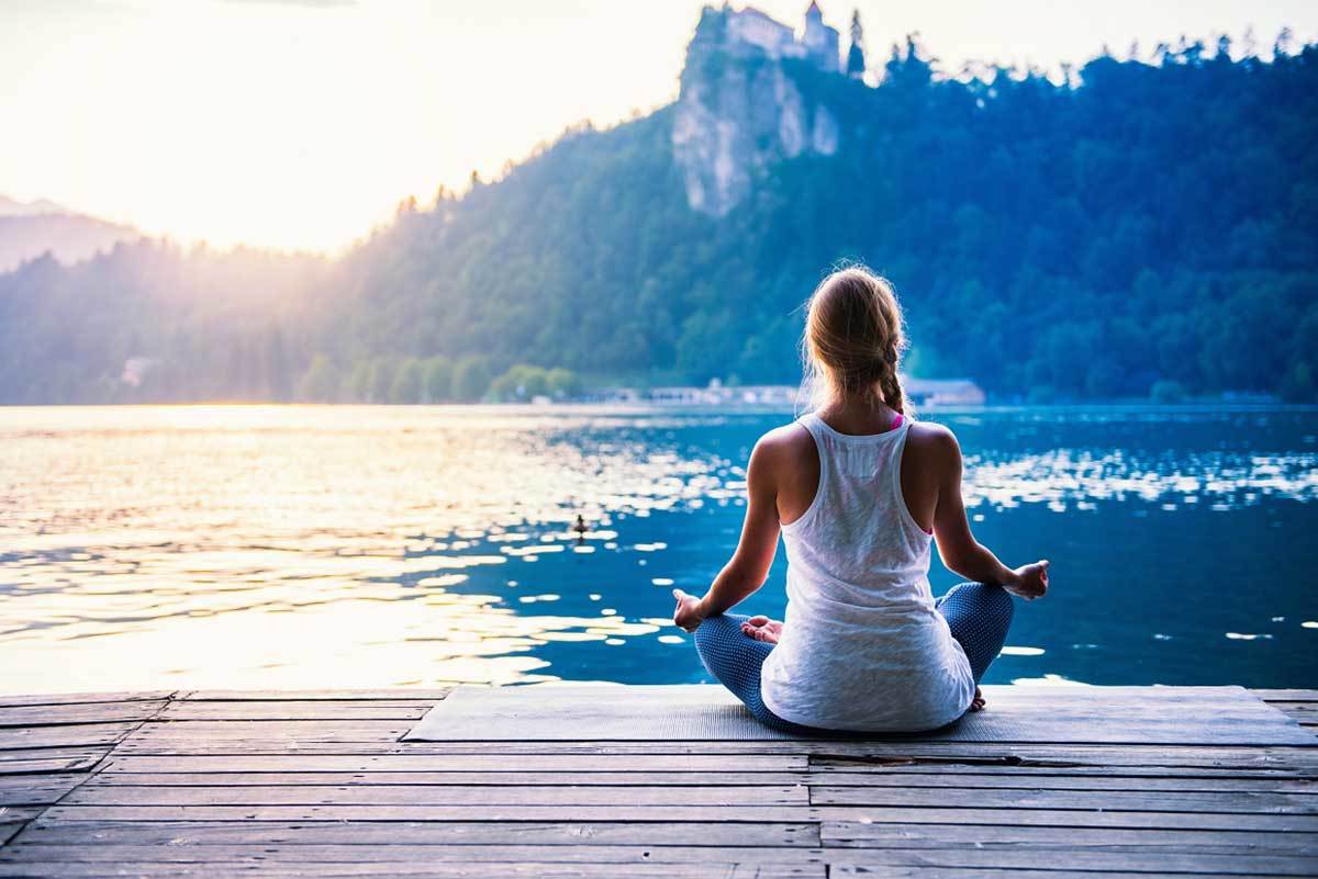 lady sitting on a dock feeling zen